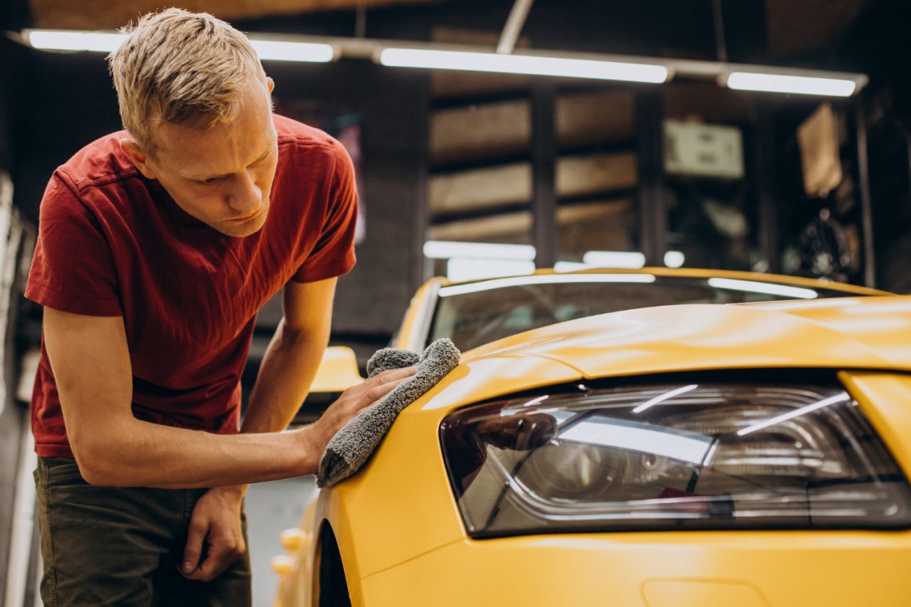 man wiping car with microfiber after wash