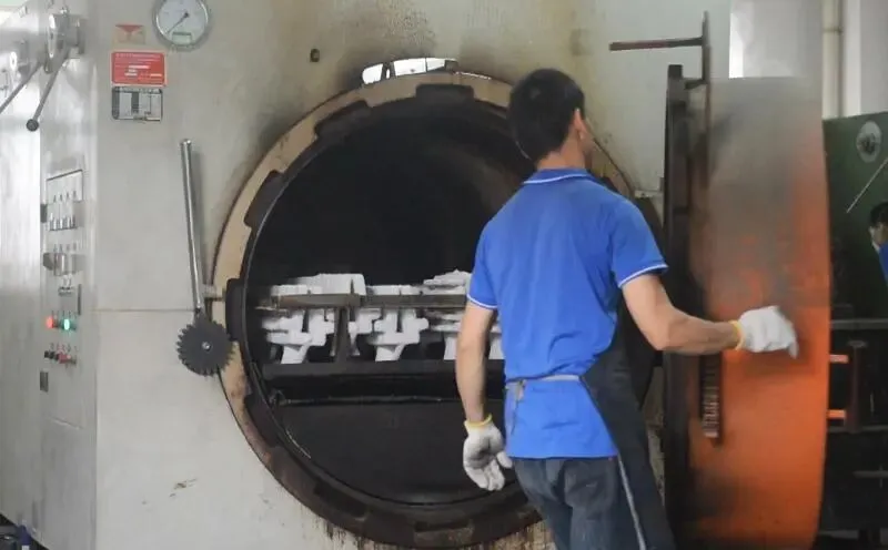 Ceramic Shell Firing Furnace Worker loading ceramic shell molds into high-temperature firing furnace
