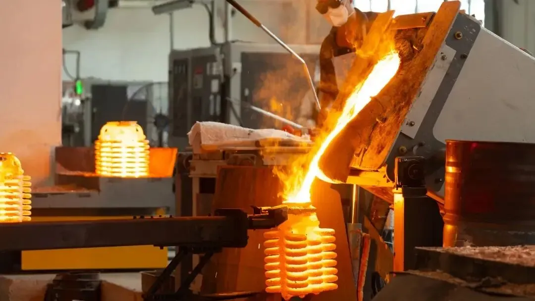 Molten metal alloy poured into ceramic investment casting shells